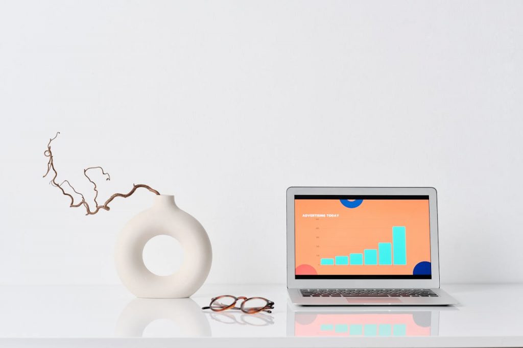 Laptop beside a Ceramic Vase